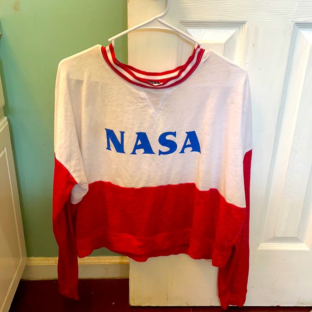 Red and white NASA long-sleeve shirt.